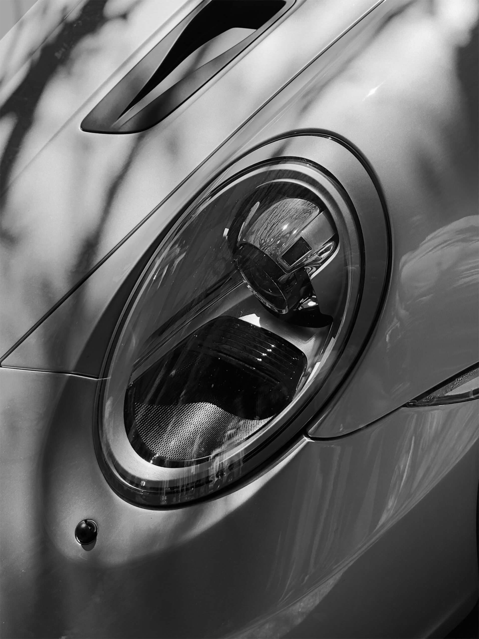 Porsche headlight close-up detail in black and white