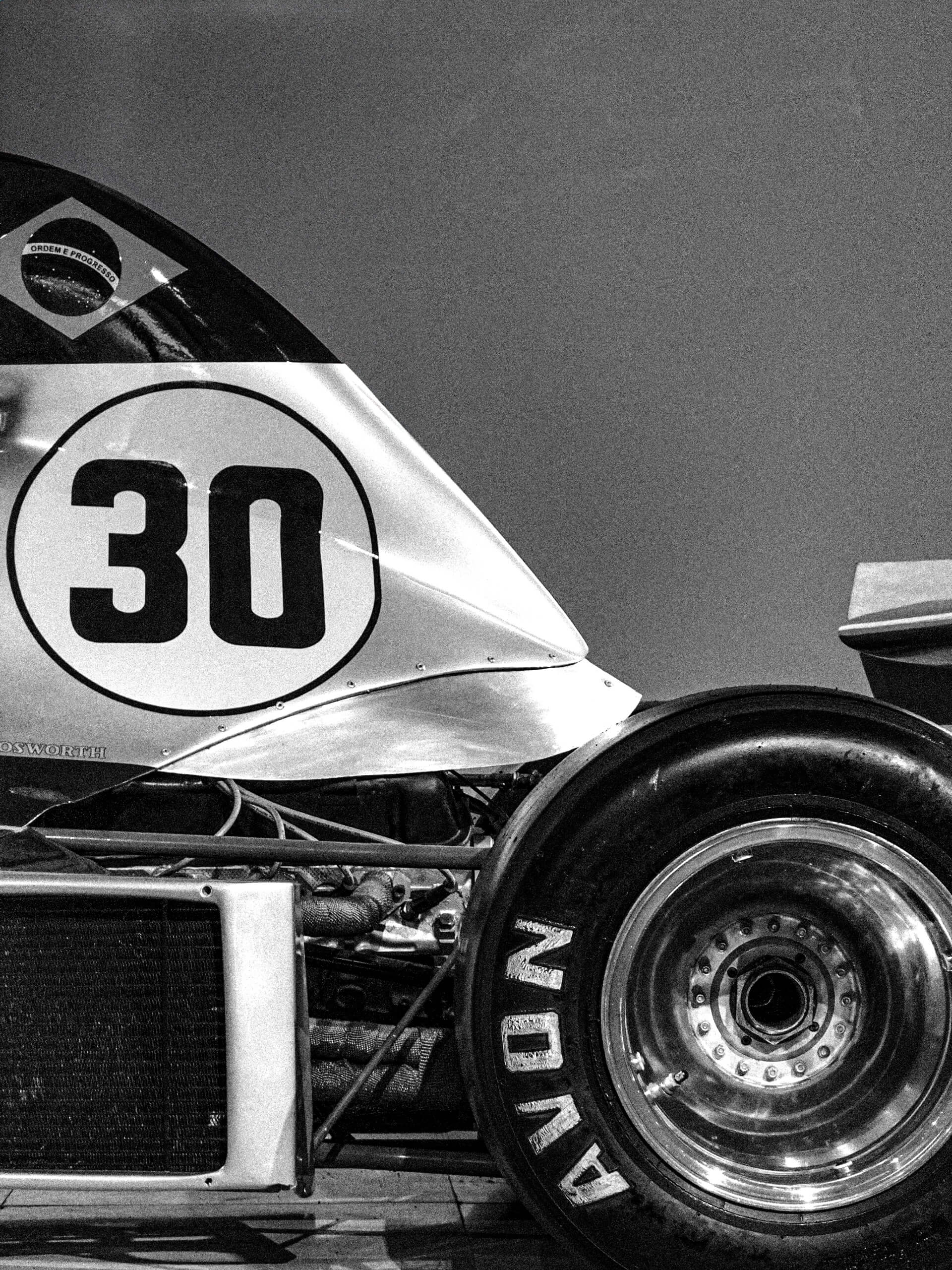 Vintage race car wheel detail with number 30 in black and white