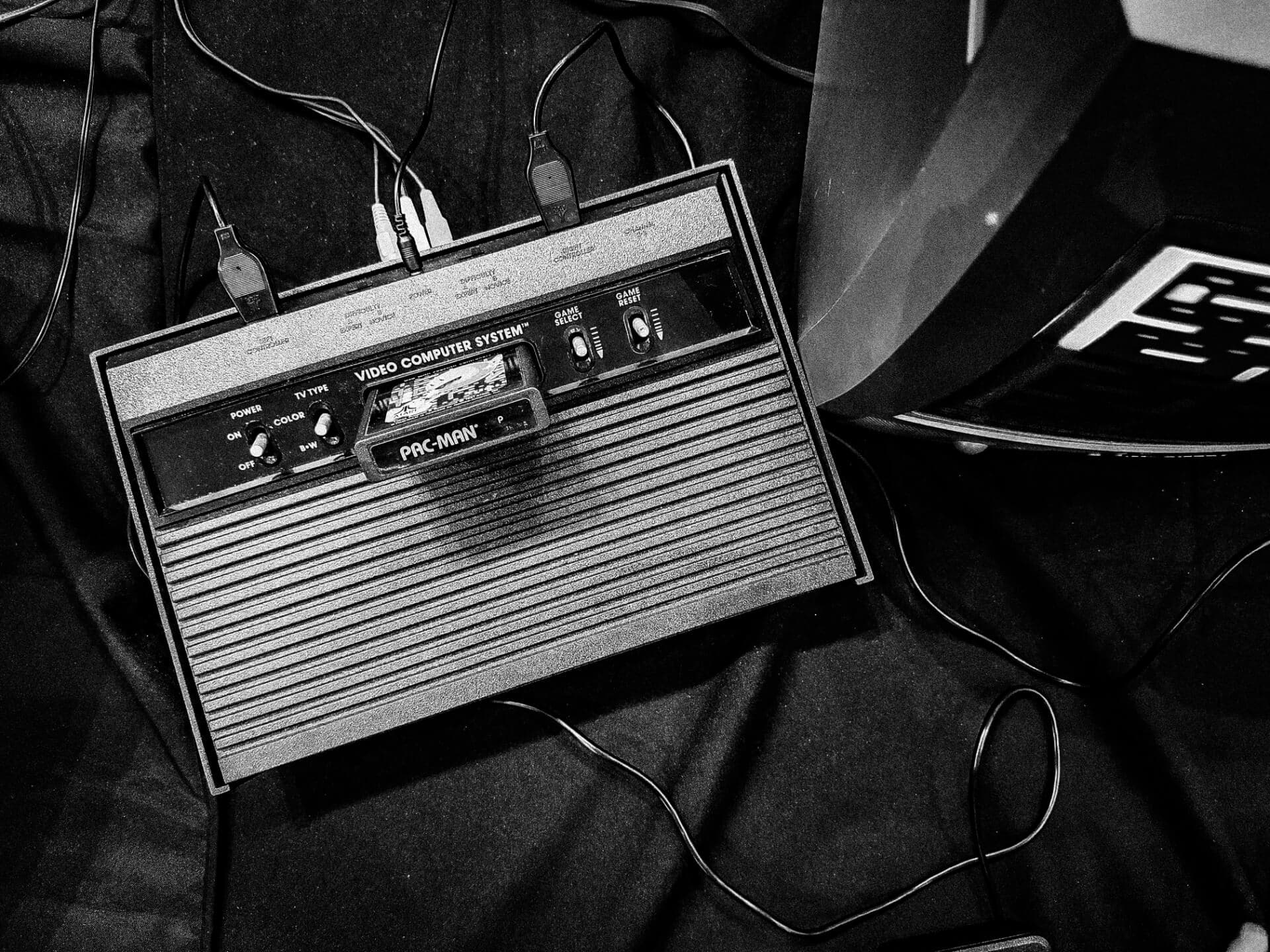 Atari 2600 console with a Pac-Man cartridge in black and white