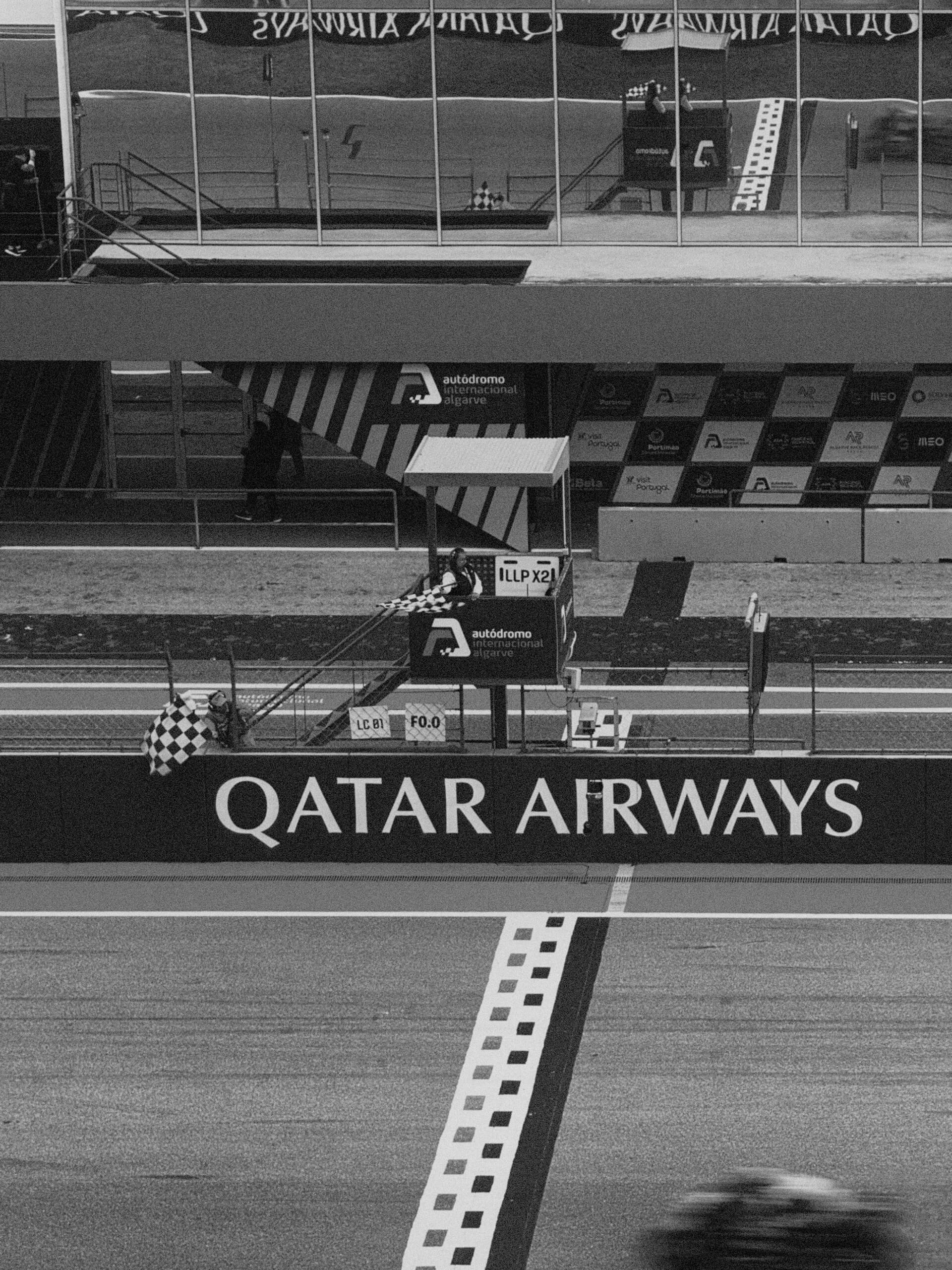 MotoGP pit lane with checkered flag at Algarve International Circuit